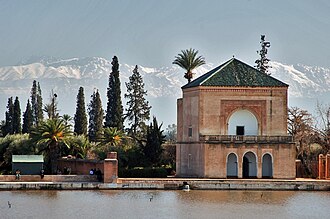 Marrakech skyline with a minaret rising above rose-toned rooftops.